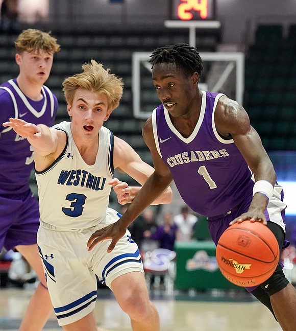 Catholic Central’s Darien Moore, right, drives past Westhill’s Luke Gilmartin during their State Class B final basketball game on Sunday March 19, 2023, at Cool Insuring Arena in Glens Falls, N.Y. Westhill wins 66-61.  Cindy Schultz for The Evangelist