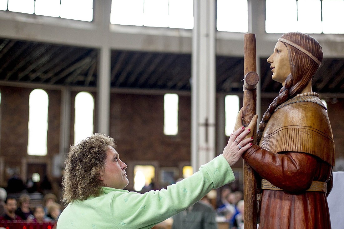 A woman is pictured in a file photo touching a statue of St. Kateri Tekakwitha after a Mass in her honor at the Shrine of Our Lady of Martyrs in Auriesville, N.Y. As part of the National Eucharistic Revival, the New York bishops are hosting a state-wide Eucharistic Congress Oct. 20-22, 2023, at the shrine. (OSV News photo/Jason Greene, Reuters)