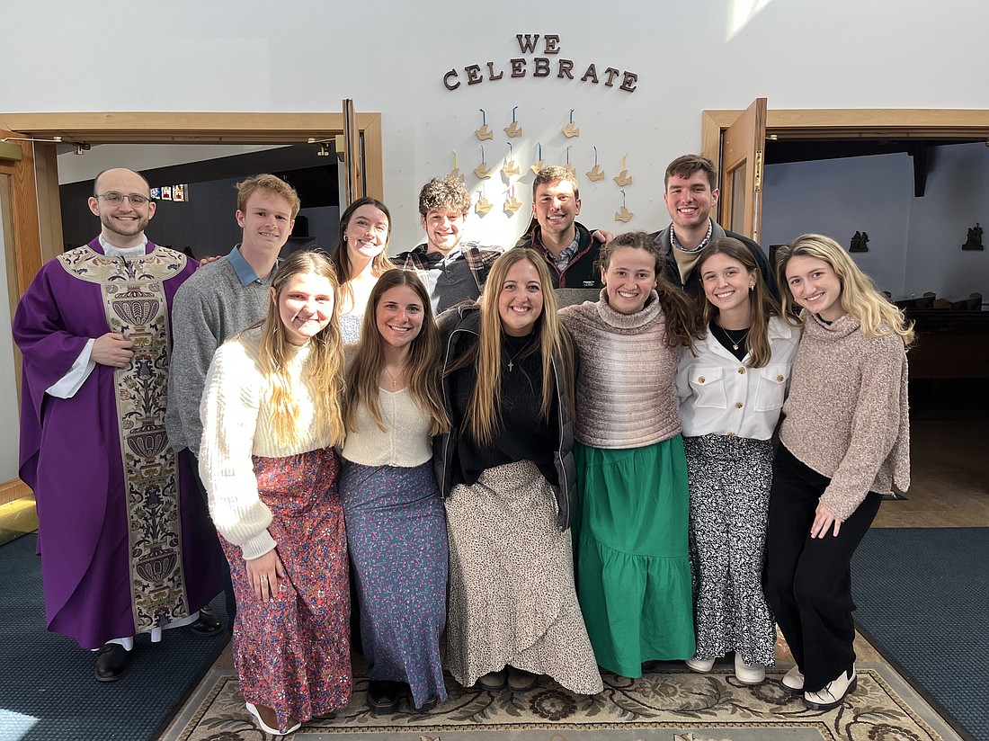 Father Samuel Ballfiore, left, welcomed 11 students from Louisiana State University during the college's spring break. Students spent a week volunteering, praying, and connecting with the local community. The week kicked off with Mass on Sunday, March 12 at Immaculate Heart of Mary in Watervliet where students (pictured here) met with parishioners after Mass. (Emily Benson photo)