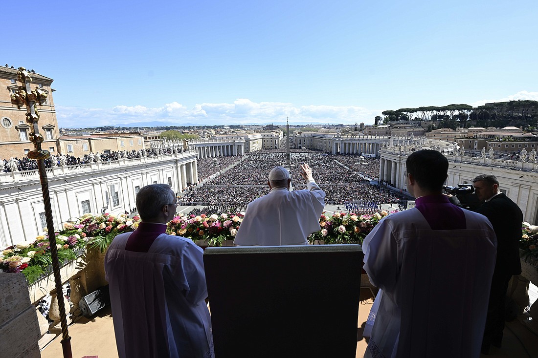 Pope Francis waves to the crowd in St. Peter's Square before he imparts his Easter blessing "urbi et orbi" (to the city and the world) from the central balcony of St. Peter's Basilica April 9, 2023. (CNS photo/Vatican Media)