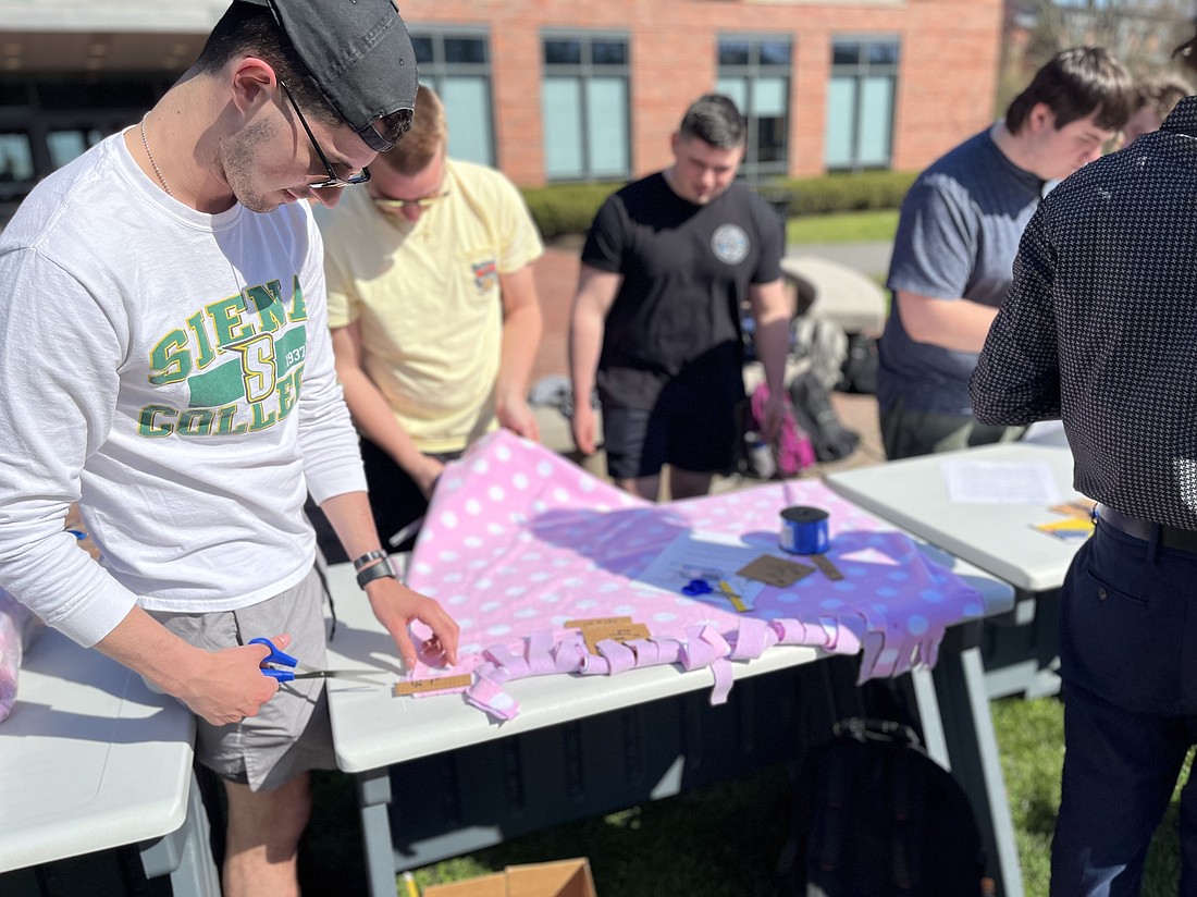 Cost accounting students at Siena College spent the day making no-sew fleece blankets for the Mohawk Hudson Humane Society on Wednesday, April 12 as part of a lesson on tracking costs. (Emily Benson photo)