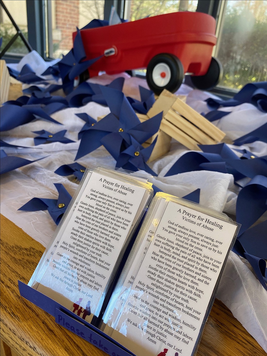 The Diocese of Albany recognized National Child Abuse Prevention Month - designated annually in April - with a window display and pinwheels in the front yard of the Pastoral Center. (Kathy Barrans photo)
