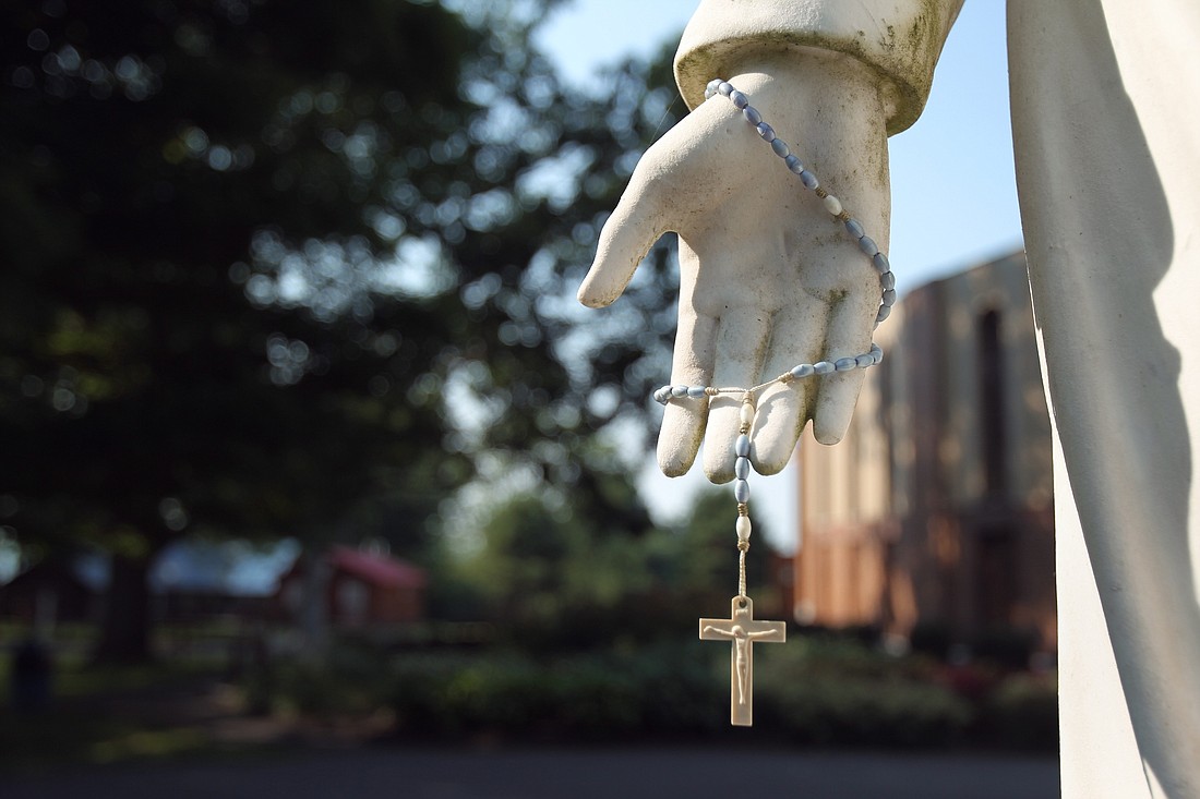 A rosary hangs from a statue of Jesus at the Shrine of Our Lady of Martyrs in Auriesville, N.Y., in this 2010 file photo. (CNS photo/Nancy Wiechec)