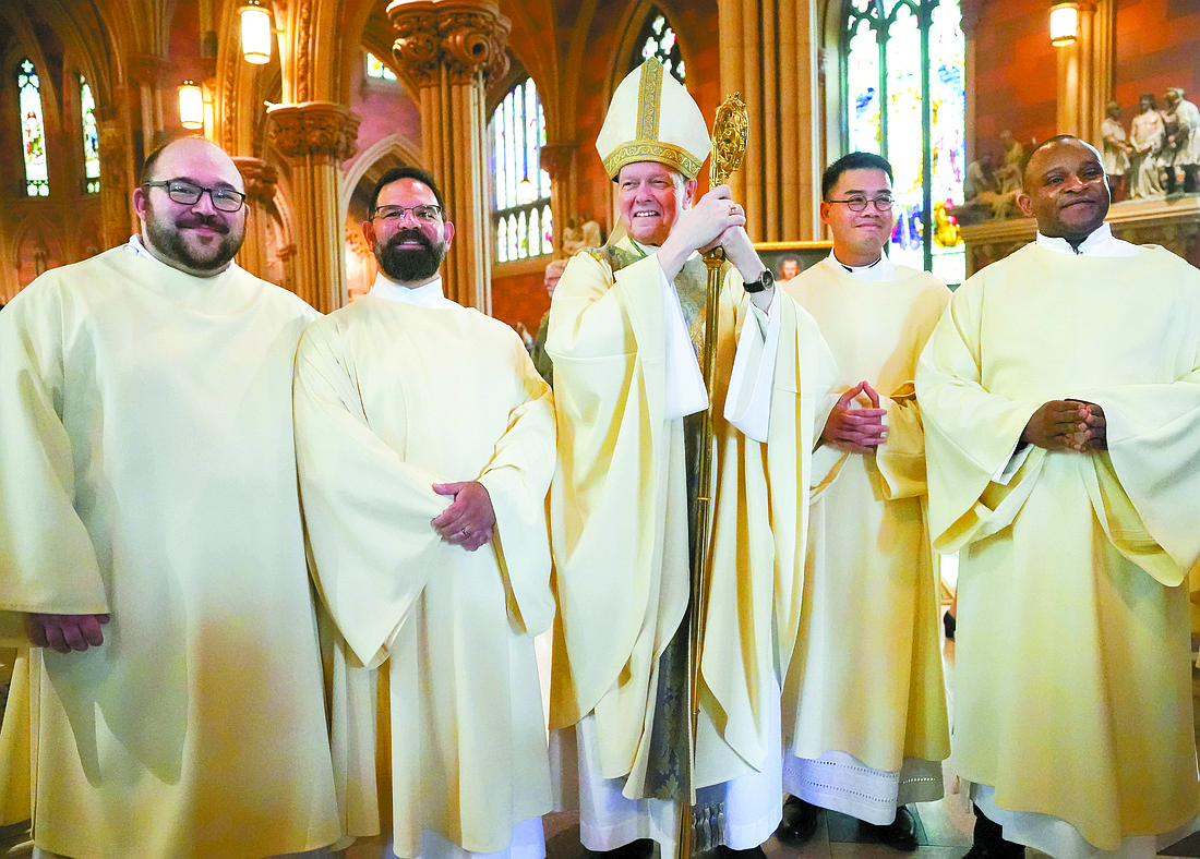 Newly ordained deacons pose with Bishop Edward B. Scharfenberger following their Ordination to the Diaconate on Saturday May 20, 2023, at the Cathedral of Immaculate Conception in Albany, N.Y. From left are Adam James Feisthamel, Eduardo Treviño Jr., Joseph Tuan Van Pham and Anthony Chibueze Onu.  Cindy Schultz for The Evangelist