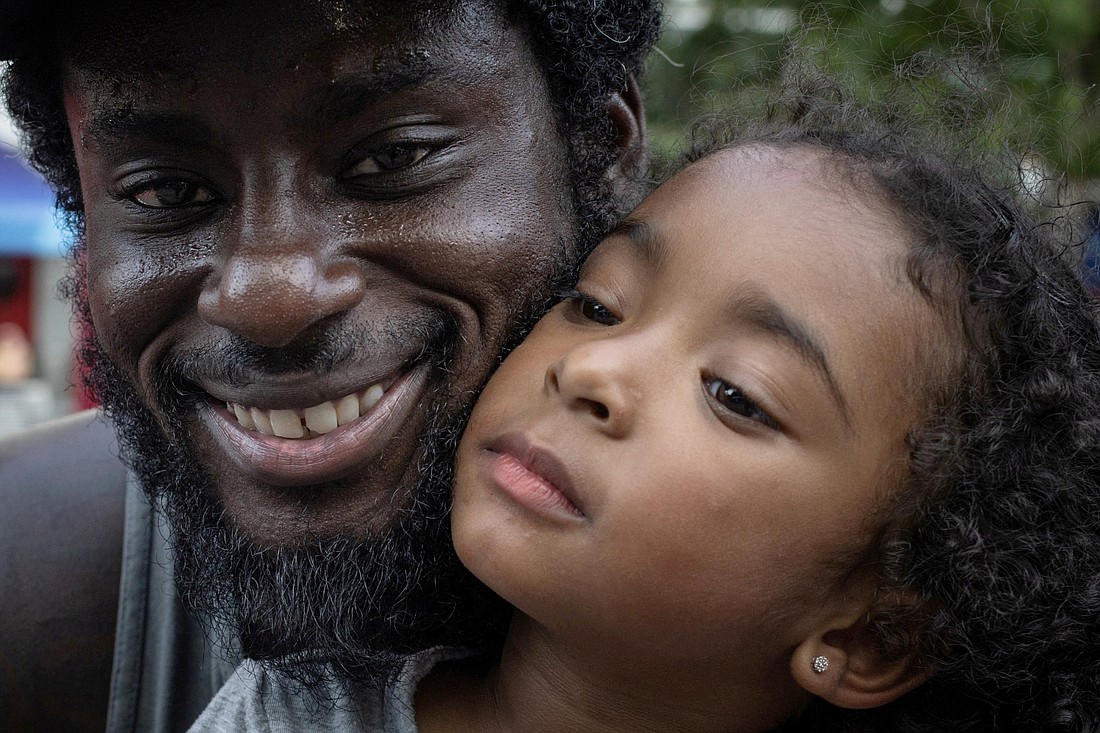 Kyle Bowman holds his 3-year-old daughter, Mila, on Father's Day June 18, 2023, during Juneteenth celebrations at Discovery Green in Houston. The celebration commemorates the fall of slavery in Galveston, Texas, two years after the Emancipation Proclamation was issued in 1863 to free enslaved Black people held in the Confederacy. The federal Juneteenth holiday was observed June 19. (OSV News photo/Adrees Latif, Reuters)