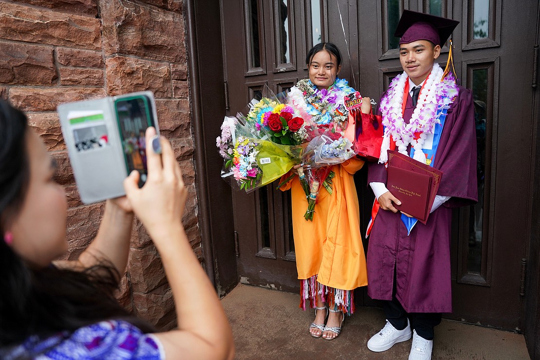 Graduates Ma “Say K Paw” Myint, left, and Hsar K’pru, are regaled in the Karen tradition as they pose for photos following Notre Dame-Bishop Gibbons commencement exercises on Saturday, June 24, 2023, at St. John the Evangelist in Schenectady, N.Y.  Cindy Schultz for The Evangelist