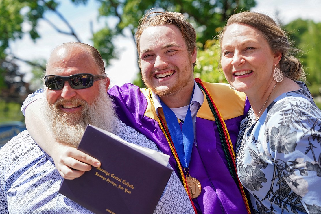 Graduate Christopher Comstock, center, celebrates graduation day with his parents Kenneth and Jennifer Comstock following Saratoga Central Catholic commencement exercises on Friday, June 23, 2023, at St. Clements Church in Saratoga Springs, N.Y.  Cindy Schultz for The Evangelist
