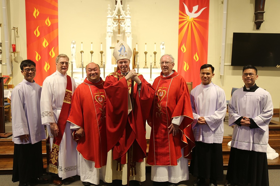 Bishop Edward B. Scharfenberger (c.) stands between Father Quy Vo, pastor of
the Church of the Holy Spirit, (l.) and Father John Bradley at Holy Spirit’s Pentecost Mass this May. The day concluded a yearlong celebration of the parish’s 100-year anniversary. (Provided photo)