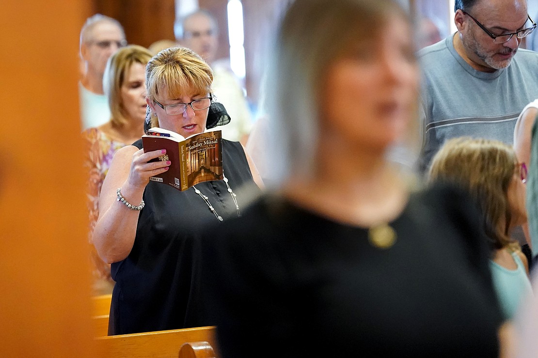 Sara Menneto, left, joins in song during mass on Sunday, July 23, 2023, at St. Isaac Jogues Chapel, which is open from Memorial Day “til the snow flies,” in Saratoga Springs, N.Y.  Cindy Schultz for The Evangelist