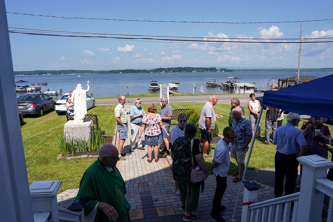 Parishioners enjoy community time that includes a view of Saratoga Lake following mass on Sunday, July 23, 2023, at St. Isaac Jogues Chapel, which is open from Memorial Day “til the snow flies,” in Saratoga Springs, N.Y.  Cindy Schultz for The Evangelist