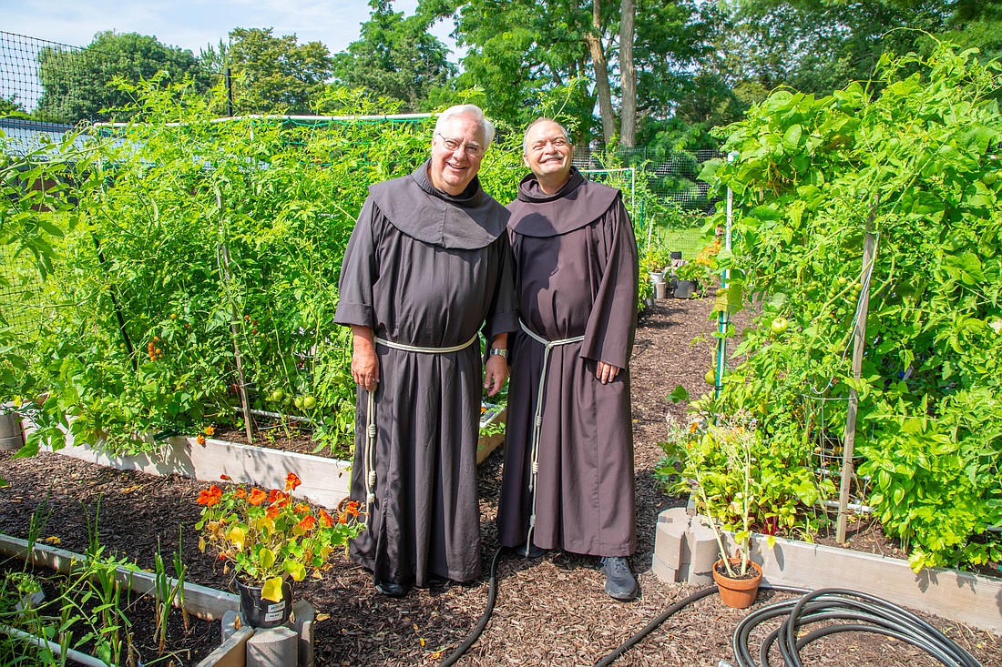 Father Bob Sandoz (l.) and Father Greg Gebbia, inspired by Pope Francis’ encyclical “Laudato Sí,” have greatly expanded the garden — which is overflowing with vegetables — behind the Siena friary. (Photos provided)