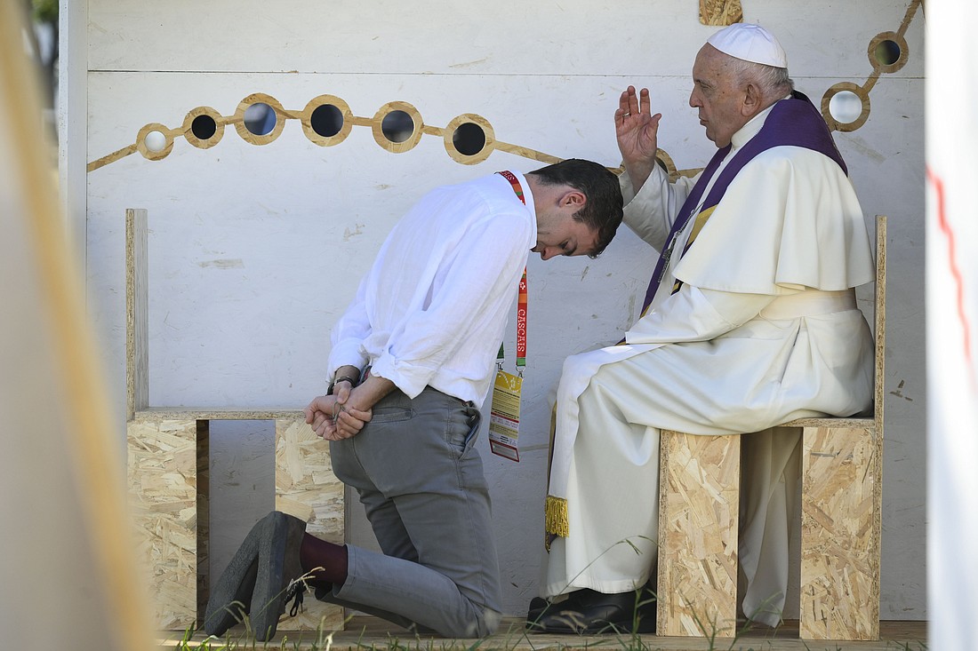 Pope Francis offers absolution to a World Youth Day pilgrim after hearing his confession in Vasco da Gama Garden in Lisbon, Portugal, Aug. 4, 2023. The pope administered the sacrament to three pilgrims: young men from Italy and Spain, and a young woman from Guatemala. (CNS photo/Vatican Media)