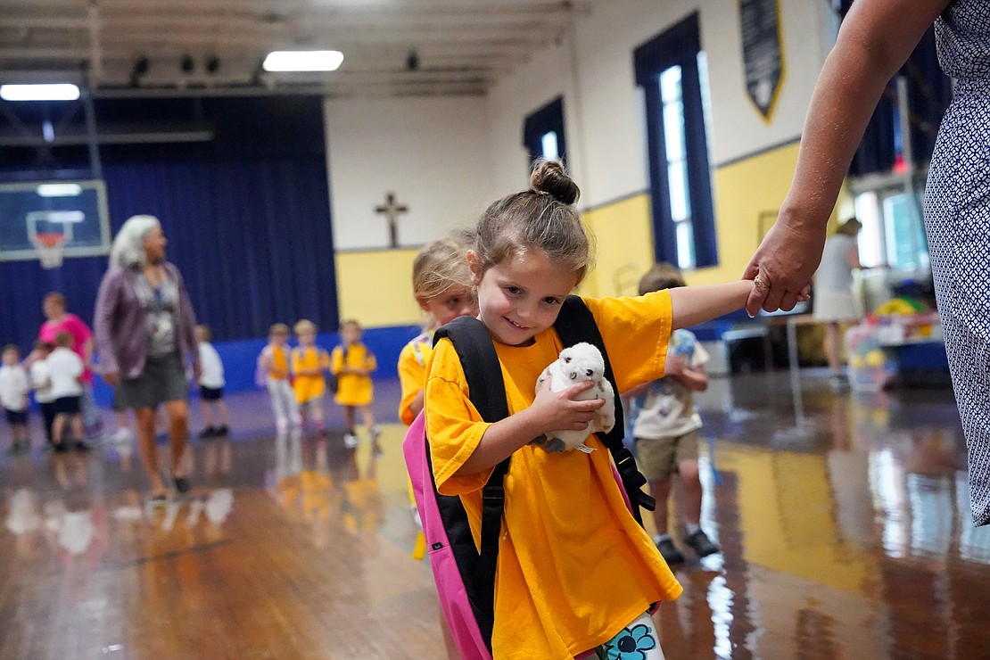 Fiona Lucca walks to class with her pre-K teacher Bridget Vavasour on Sept. 12 at St. Clement's School in Saratoga Springs. Cindy Schultz photo for The Evangelist