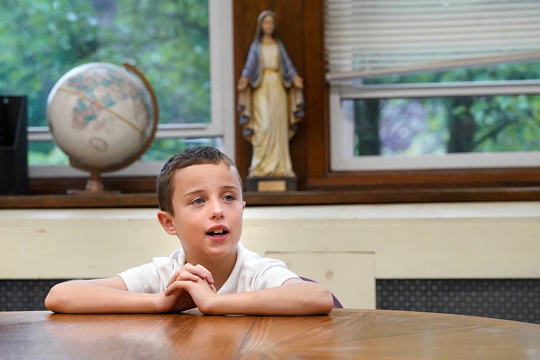 Third grader James Kelley, 8, says a prayer in Spanish during Spanish class on Sept. 12 at St. Clement's School in Saratoga Springs. Cindy Schultz photo for The Evangelist