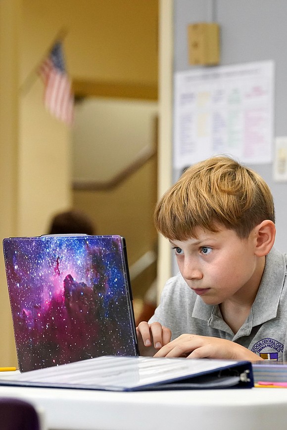 Sixth grader Jake Durfee,11, works on his laptop during World History class on Sept. 13  at Saratoga Central Catholic School in Saratoga Springs. Cindy Schultz photo for The Evangelist