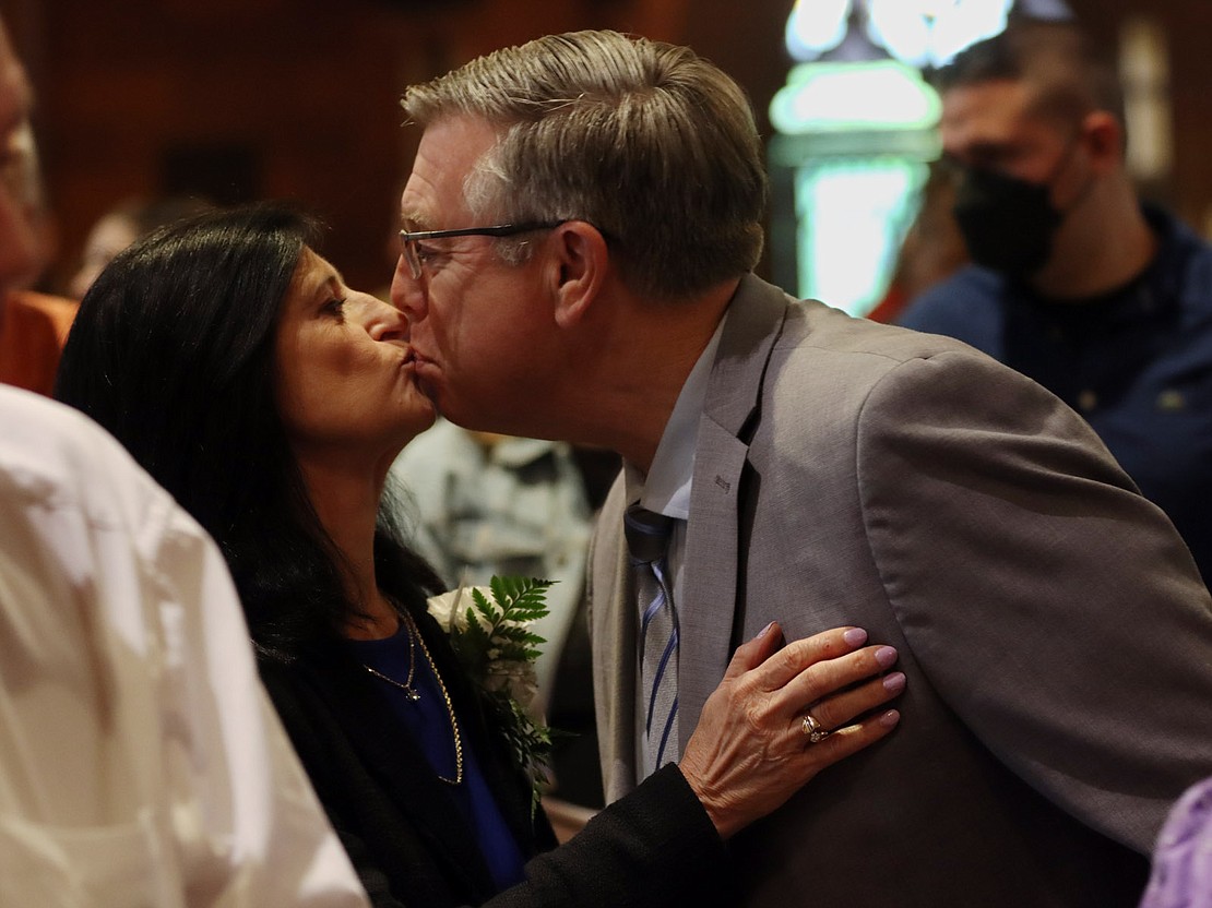 Rosemary and Monty Pyle of Niskayuna, married 40 years, kiss during the Rite of Peace during the 51st Annual Diocesan Marriage Jubilee Celebration on Sept. 23 at the Cathedral of the Immaculate Conception. (Thomas Killips photo)
