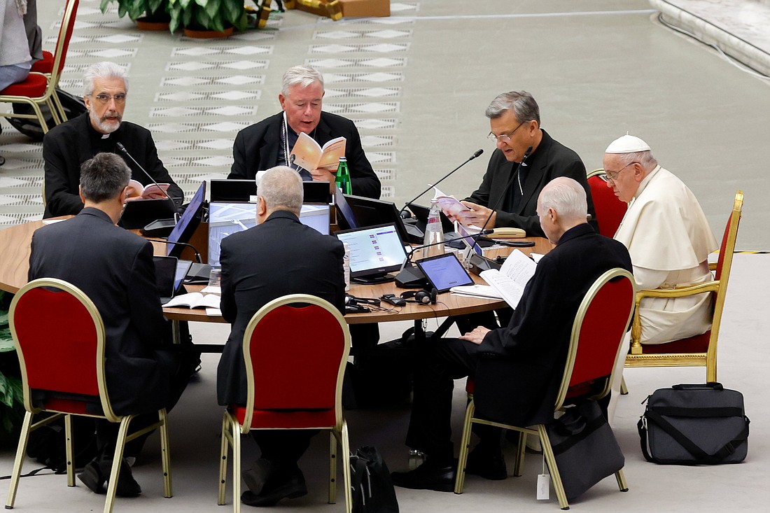 Pope Francis prays in the Vatican's Paul VI Audience Hall at the beginning of a working session of the assembly of the Synod of Bishops Oct. 6, 2023. (CNS photo/Lola Gomez)