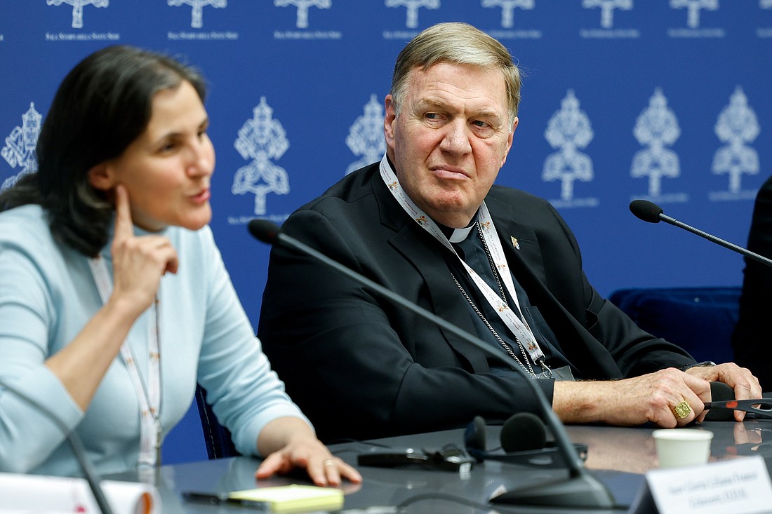 Cardinal Joseph W. Tobin of Newark, N.J., listens to Sister Liliana Franco Echeverri, a member of the Company of Mary and president of the Latin American Confederation of Religious, as she speaks during a briefing about the assembly of the Synod of Bishops at the Vatican Oct. 10, 2023. (CNS photo/Lola Gomez)