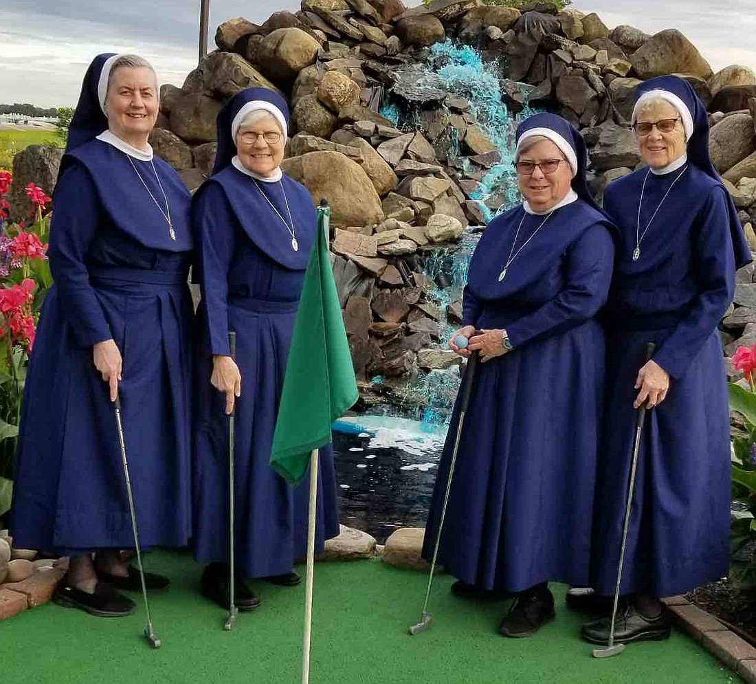 Sister Miriam Ann (clockwise from the left), Sister Mary Stephen, Sister James Marie, and Sister Mary Dominica - all Sisters of the Presentation of the Blessed Virgin Mary - enjoy a night out at a local mini-golf course. (Provided photo)