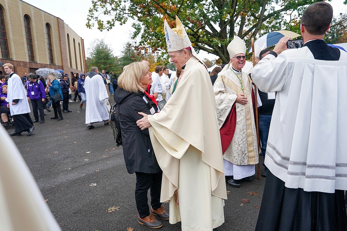 Bishop Edward B. Scharfenberger speaks with a parishioner after Mass during the New York State Eucharistic Congress on Oct. 21 at Our Lady of Martyrs Shrine in Auriesville. (Cindy Schultz photo for The Evangelist)