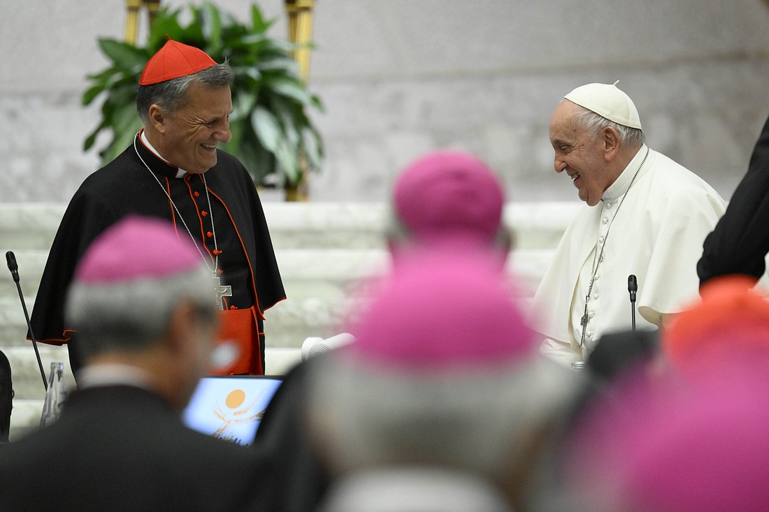 Pope Francis smiles at Cardinal Mario Grech, secretary-general of the Synod of Bishops, as the first assembly of the synod on synodality concludes Oct. 28, 2023, in the Paul VI Hall at the Vatican. (CNS photo/Vatican Media)