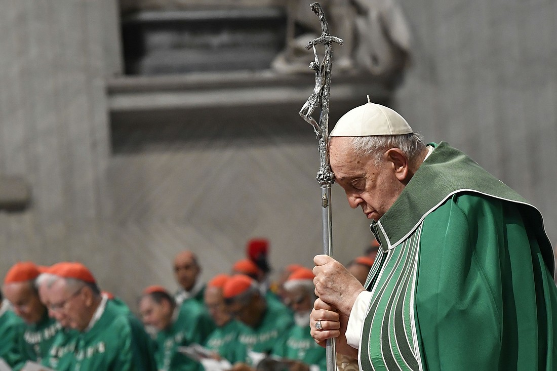 Pope Francis prays while holding a crosier during Mass in St. Peter's Basilica at the Vatican Oct. 29, 2023, marking the conclusion of the first session of the Synod of Bishops on synodality. (CNS photo/Vatican Media)