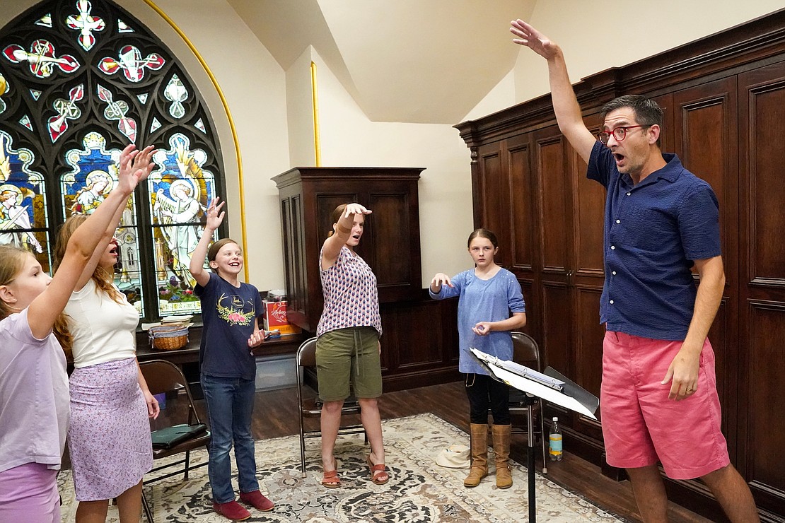 Director of music and choir master Tim Reno, (r.) leads a visual exercise of notes in the scale during a children’s choir practice at the Cathedral of the Immaculate Conception in Albany. (Cindy Schultz photo for The Evangelist)