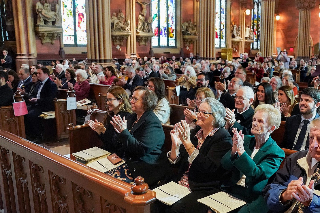 The congregation applauds as candidates for deacon and priest are introduced. (Cindy Schultz photo for The Evangelist)