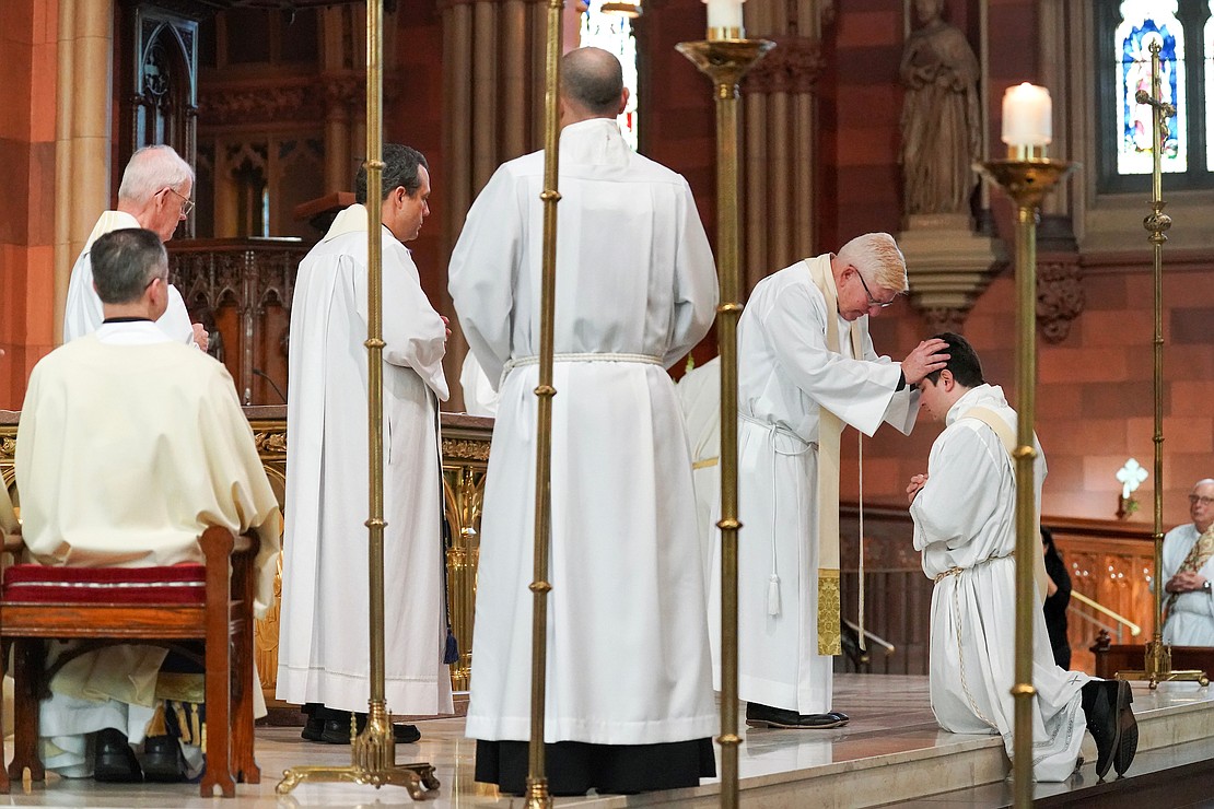 Priests lay their hands on candidate Daniel Vallejo during his Ordination Mass on Nov. 18 at the Cathedral of the Immaculate Conception in Albany. (Cindy Schultz photo for The Evangelist)