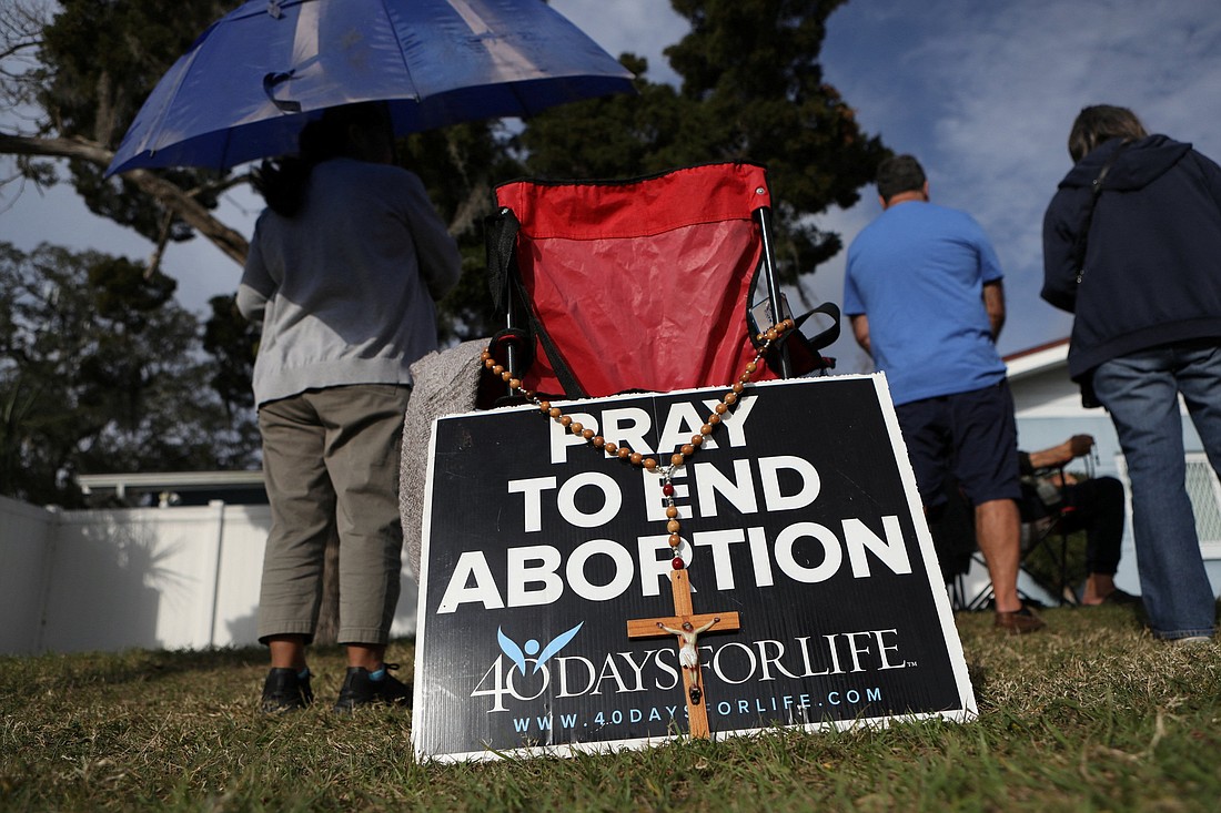 Pro-life activists pray with rosaries as clients arrive at the Bread and Roses Woman's Health Center, a clinic that provides abortions in Clearwater, Fla., Feb. 11, 2023. Florida's Catholic  bishops in a Sept. 16 statement urged the faithful not to sign a petition to put an amendment to the state constitution on the 2024 ballot that would ban any government regulation of abortion. (OSV News photo/Octavio Jones, Reuters)