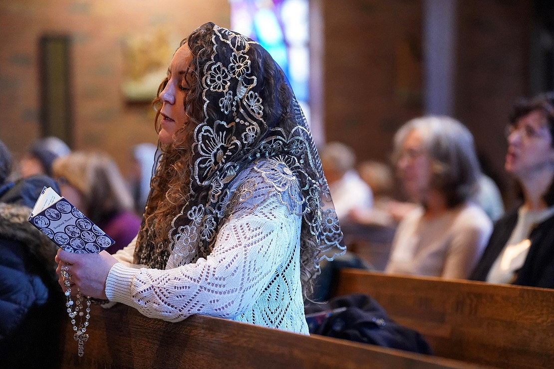 Ashley Putney of Little Falls takes part in the rosary prayers during the Unleashing Love Women’s Conference on Dec. 9 at St. Pius X Church in Loudonville.  (Cindy Schultz photo for The Evangelist)