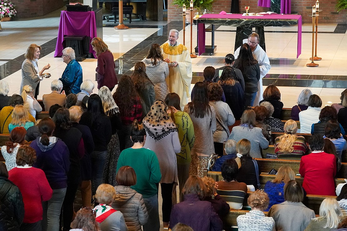 Women queue up to receive communion from Bishop Edward B. Scharfenberger and others during the Unleashing Love Women’s Retreat on Dec. 9 at St. Pius X Church in Loudonville. (Cindy Schultz photo for The Evangelist)