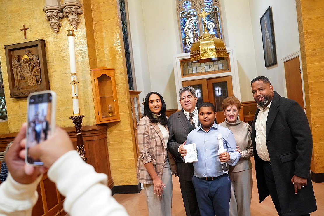 Eric Reyes, 10, center, who was just baptized, poses for a picture with his parents and godparents on Sunday, Dec. 3, 2023, at Blessed Sacrament in Albany, N.Y.  Cindy Schultz for The Evangelist