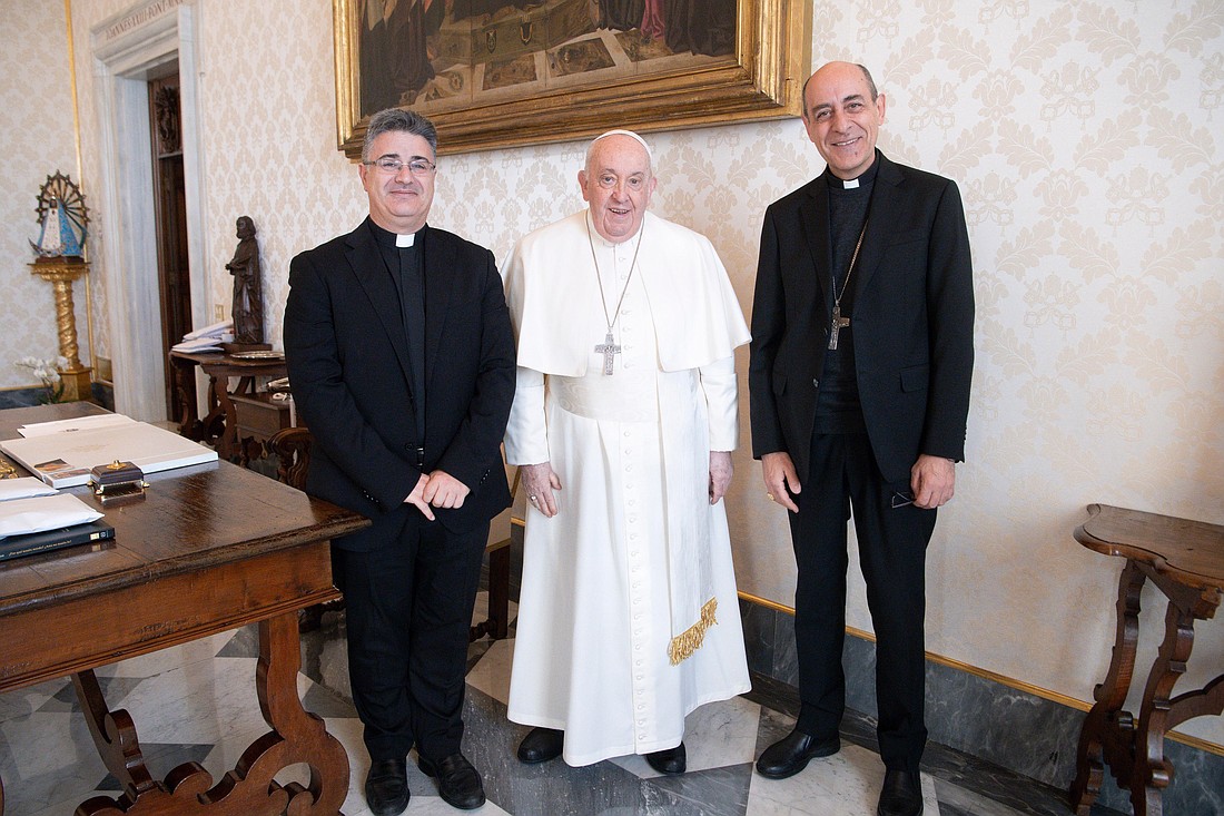 Pope Francis poses for a photo with Msgr. Armando Matteo, left, secretary of the doctrinal section of the Dicastery for the Doctrine of the Faith, and Cardinal Víctor Manuel Fernández, dicastery prefect, during a meeting in the library of the Apostolic Palace at the Vatican Dec. 18, 2023. (CNS photo/Vatican Media)