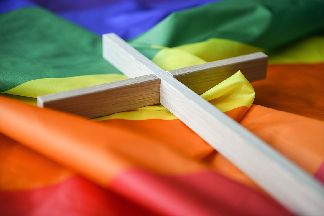 A wooden cross lies on a rainbow flag in Bonn, Germany,  March 16, 2021. Experts are responding to a Dec. 18, 2023, Vatican declaration on the possibility of blessing couples in irregular and same-sex unions without officially validating their status or changing in any way the Catholic Church’s perennial teaching on marriage. (OSV News photo/Julia Steinbrecht, KNA)