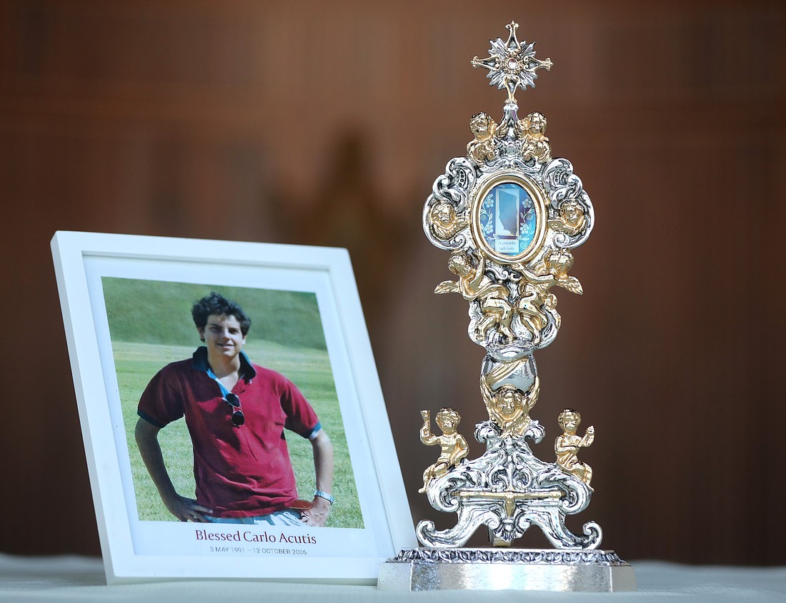 The reliquary containing a relic of Blessed Carlo Acutis and his photo are displayed in the chapel at the headquarters of the U.S. Conference of Catholic Bishops in Washington Aug. 16, 2022. The Italian teen had a great love of the Eucharist and used his technology skills to build an online database of eucharistic miracles around the world. (CNS photo/Bob Roller)