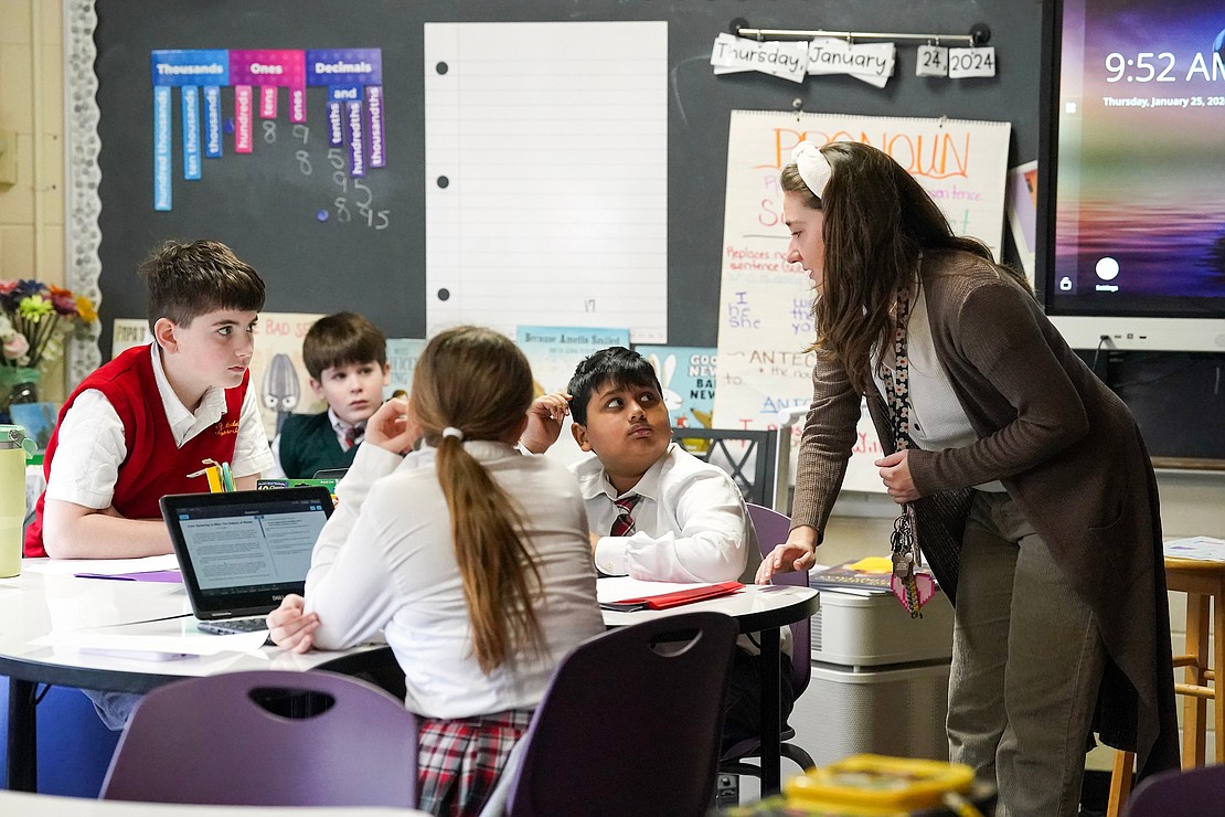 Fifth-grade teacher Rebecca Scorzella checks in on her students while they practice a New York State exam at St. Madeleine Sophie School. (Cindy Schultz photo for The Evangelist)