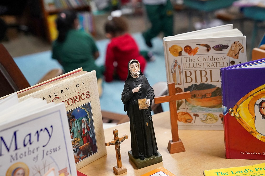 St. Madeleine Sophie Barat, the school’s patron saint, is on display with the Bible and other religious books in the first-grade class at St. Madeleine Sophie School. (Cindy Schultz photo for The Evangelist)