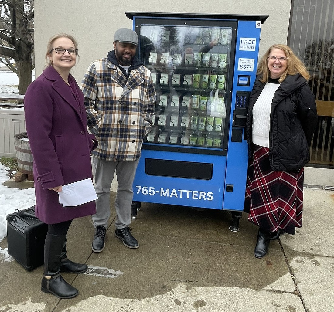 Candace Ellis, executive director of Catholic Charities Care Coordination Services (from l.), Hudson Mayor Kamal Johnson and Theresa Lux, executive director at Catholic Charities of Columbia and Greene Counties, stand next to the new harm reduction vending machine in Hudson. (Photo provided)