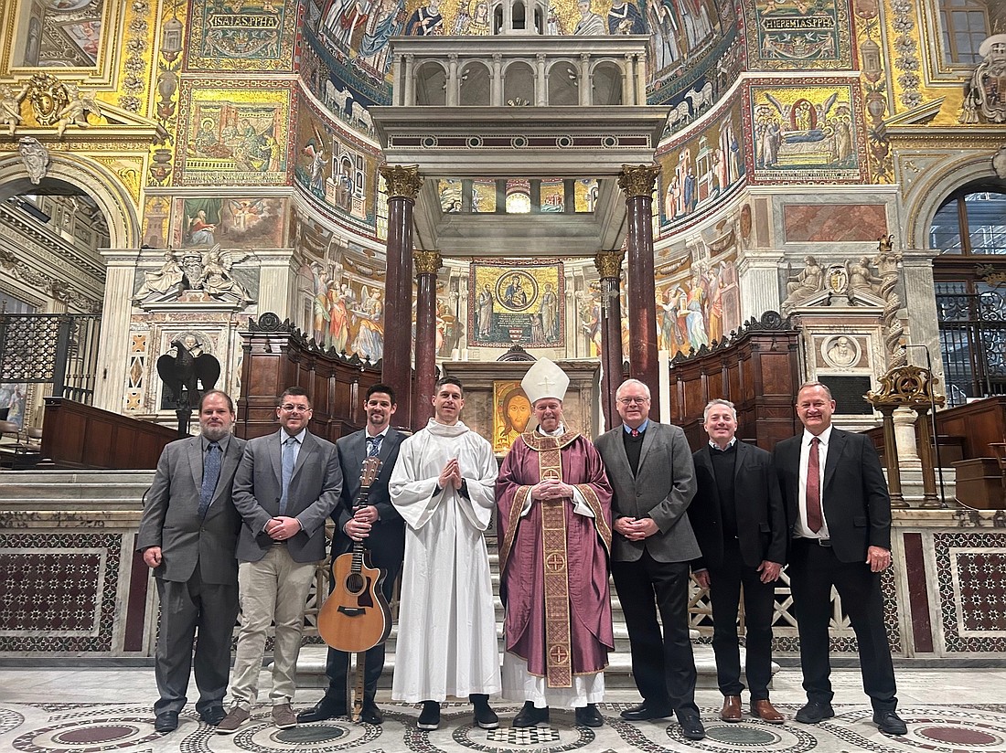 During a recent trip to Rome, which culminated in an audience with Cardinal Michael Czerny, Prefect, and other members of the Dicastery for the Promotion of Integral Human Development, Bishop Edward B. Scharfenberger is seen with members of his group at Mass in Santa Maria in Trastevere. Those joining the Bishop (c.) include (from l.): Dan Kemmet, Jeff Runyan, Danny Leger, Dan Jasón, Dr. Joseph Dutkowsky, Rick Guidotti and Craig Johring. The only two from the group that are missing are Father Anthony Ligato and Seminarian Alex Turpin. (Photo courtesy Bishop Scharfenberger)