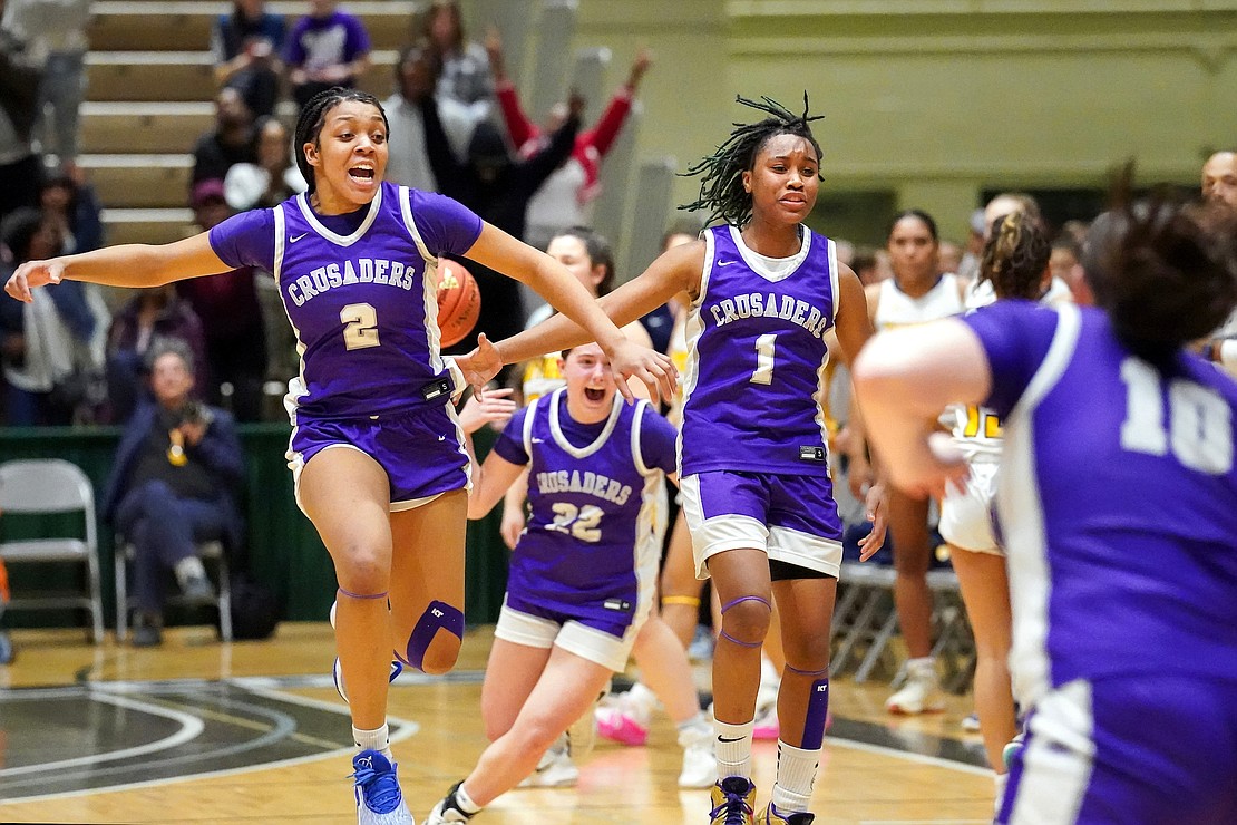 Catholic Central’s Tanavia Turpin, left, Gabriella DiBacco, center, and El’Dior Dobere celebrate their 64-62 championship win over Walter Panas in the Class A state final basketball game on Saturday, March 16, 2024, at Hudson Valley Community College in Troy, N.Y.  Cindy Schultz for The Evangelist