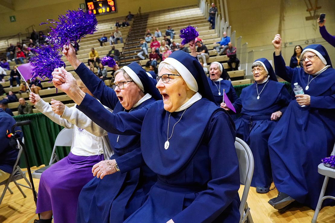 Sister Mary Stephen Vamosy, center and, to her right, Sister James Marie Carras, other St. Coleman’s Convent nuns, sit courtside and cheer for Catholic Central in their Class A state final basketball game on Saturday, March 16, 2024, at Hudson Valley Community College in Troy, N.Y. CCS wins 64-62 over Walter Panas.  Cindy Schultz for The Evangelist