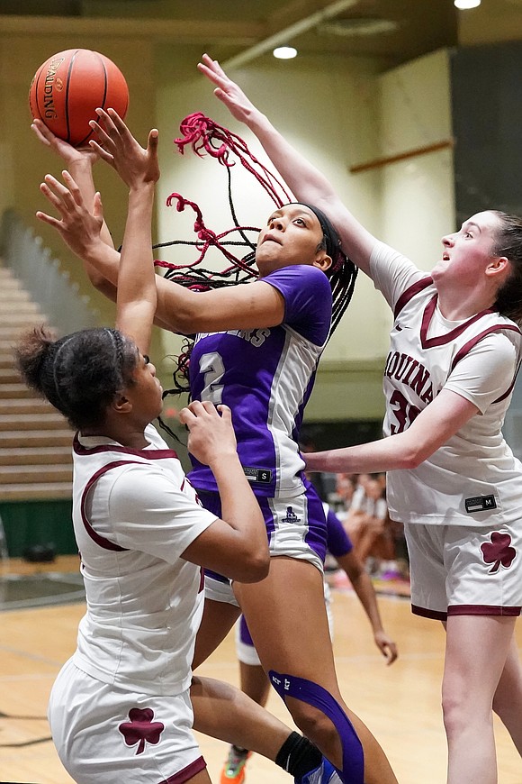 Catholic Central’s Tanavia Turpin, center, shoots for the hoop as Aquinas Institute’s Jade Harvey, left, and Molly O’Toole defend during in their Class A Semifinal basketball game on Friday, March 15, 2024, at Hudson Valley Community College in Troy, N.Y. CCS wins 63-46.  Cindy Schultz for The Evangelist