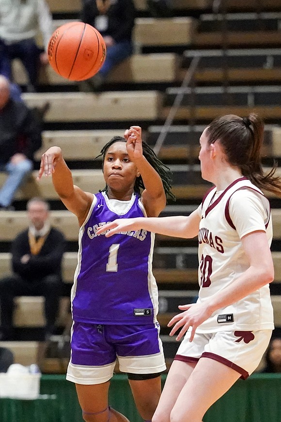 Catholic Central’s El’Dior Dobere, left, passes  the ball as Aquinas Institute’s Molly O’Toole defends during in their Class A semifinal basketball game on Friday, March 15, 2024, at Hudson Valley Community College in Troy, N.Y. CCS wins 63-46.  Cindy Schultz for The Evangelist