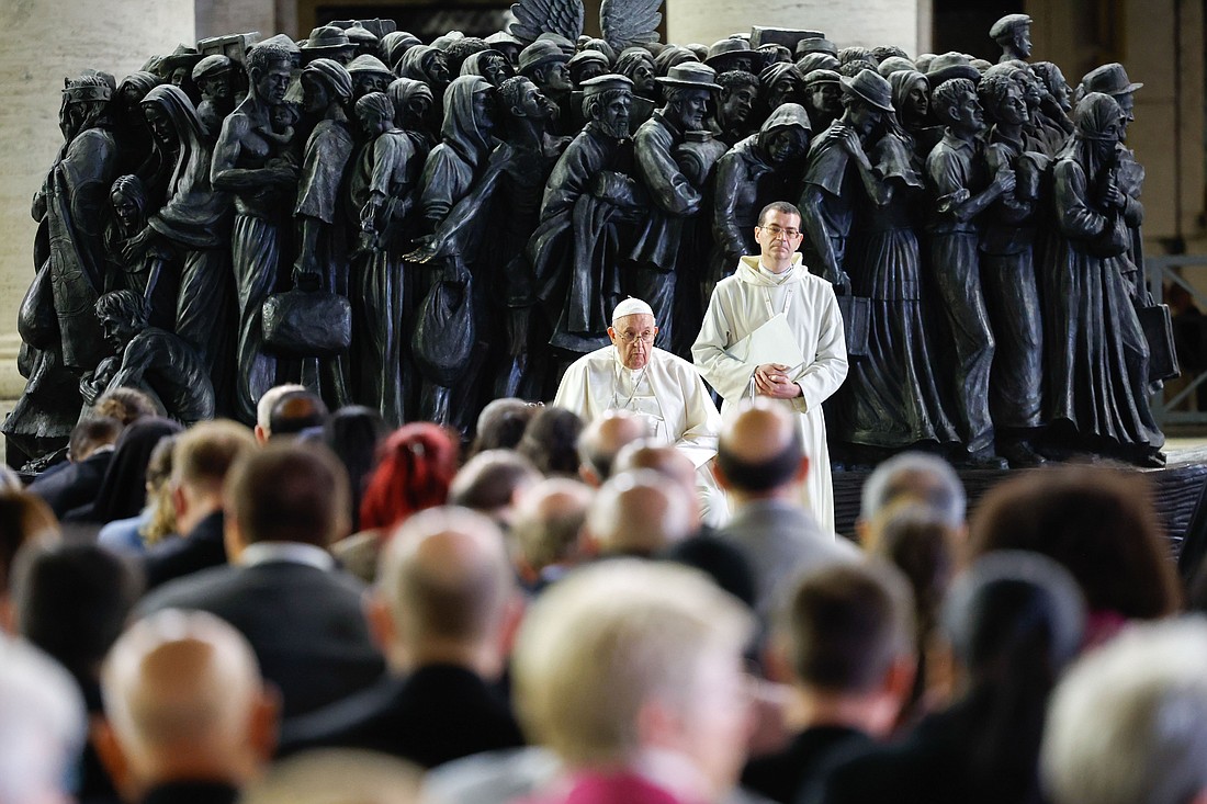 Pope Francis shares a moment of silence with members of the assembly of the Synod of Bishops at the end of a prayer for migrants and refugees in St. Peter's Square at the Vatican Oct. 19, 2023. The service took place around "Angels Unawares," a sculpture by Canadian Timothy Schmalz, depicting a boat with 140 figures of migrants from various historical periods and various nations. (CNS photo/Lola Gomez)
