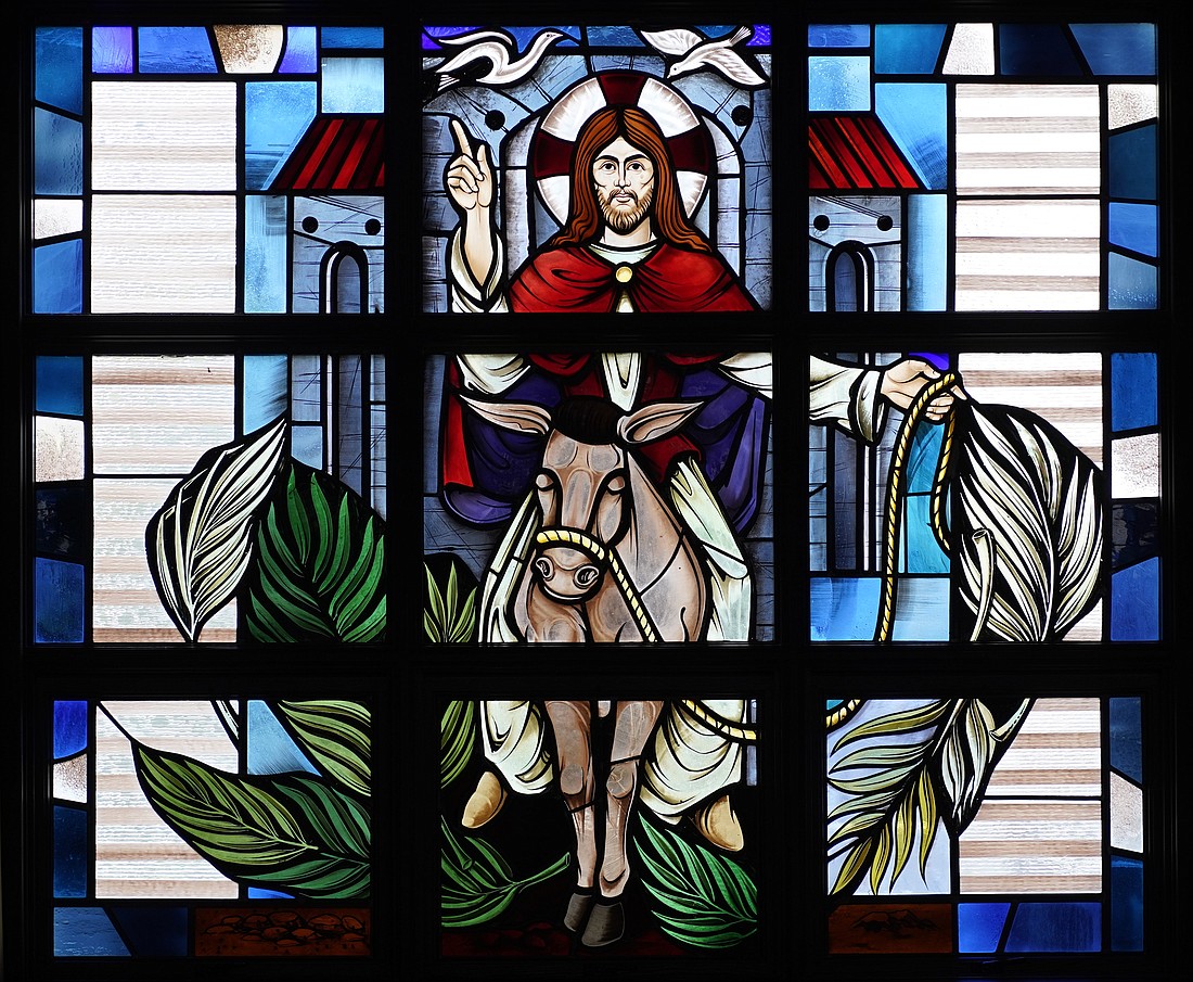 Christ's entry into Jerusalem prior to his crucifixion is depicted in a stained-glass window at Assumption of the Blessed Virgin Mary Church in Centereach, N.Y. Palm Sunday, also known Passion Sunday, commemorates the event and marks the beginning of Holy Week. It is observed March 24 in 2024. (OSV News photo/Gregory A. Shemitz)