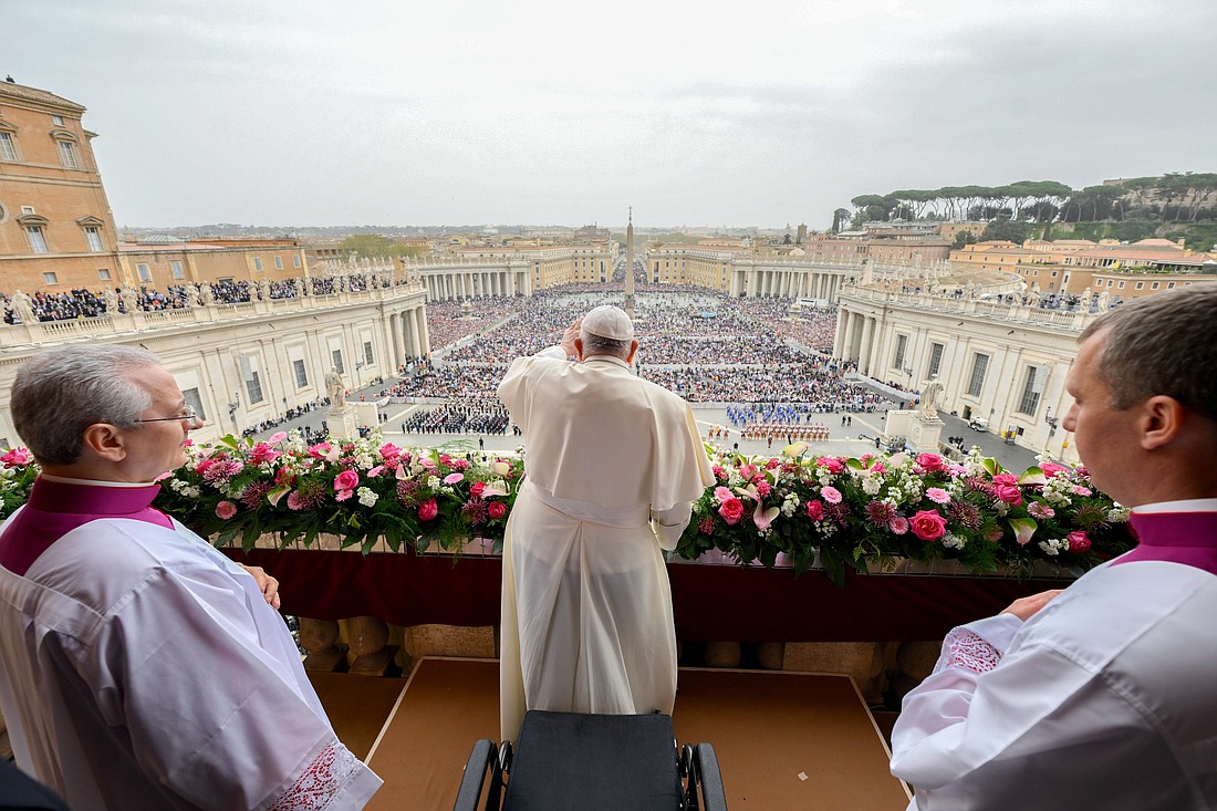Pope Francis greets the crowd after delivering his Easter message and blessing "urbi et orbi" (to the city and the world) from the central balcony of St. Peter's Basilica at the Vatican March 31, 2024. (CNS photo/Vatican Media)