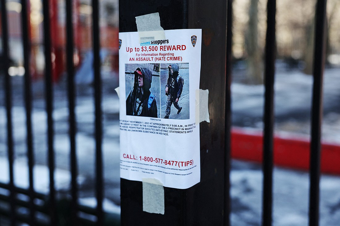 A New York City Police Department reward poster for a suspect in an alleged hate crime attack hangs from a fence in New York City's Chinatown neighborhood Jan. 22, 2024. The New York State Catholic Conference has thrown its support behind state lawmakers' effort in the New York Legislature to expand its hate crimes statute. (OSV News photo/Shannon Stapleton, Reuters)