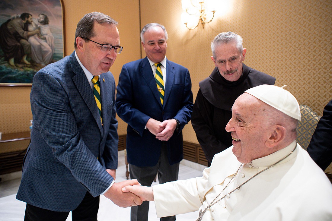 President Seifert shakes hands with Pope Francis beside Tom Baldwin Jr. '81 and Father Michael Perry. The meeting happened in the Paul VI Pavilion in Vatican City during the college's pilgrimage in April. (Provided photo)