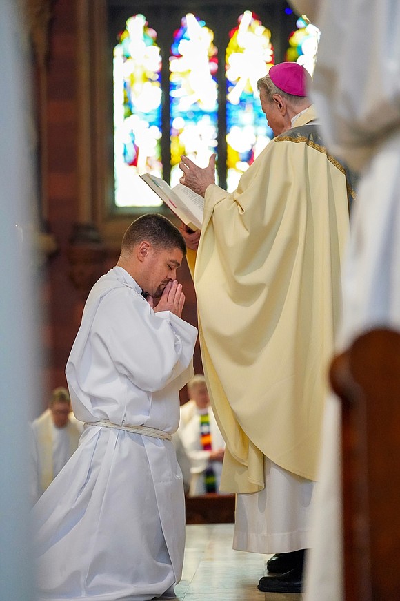 Bishop Edward B. Scharfenberger, right, reads the prayer of ordination to Eric Ramirez during his Ordination of Deacons on Saturday, May 18, 2024, at The Cathedral of the Immaculate Conception in Albany, N.Y.  Cindy Schultz for The Evangelist